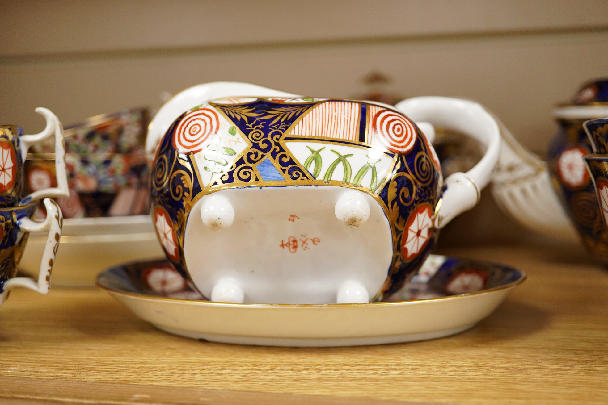A 19th century Derby Imari pattern part tea set including a teapot a pair of 19th century botanical dishes and six small ironstone dishes.